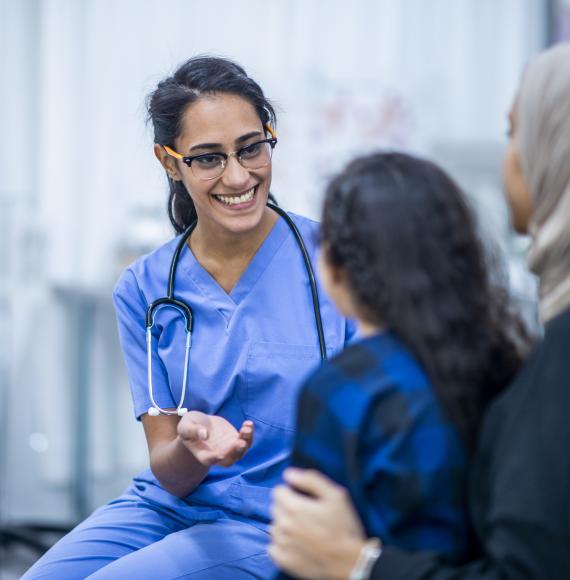 Female health professional seeing to a young female patient