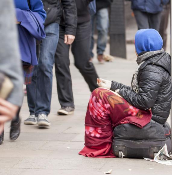 Homeless female sat asking for spare change 