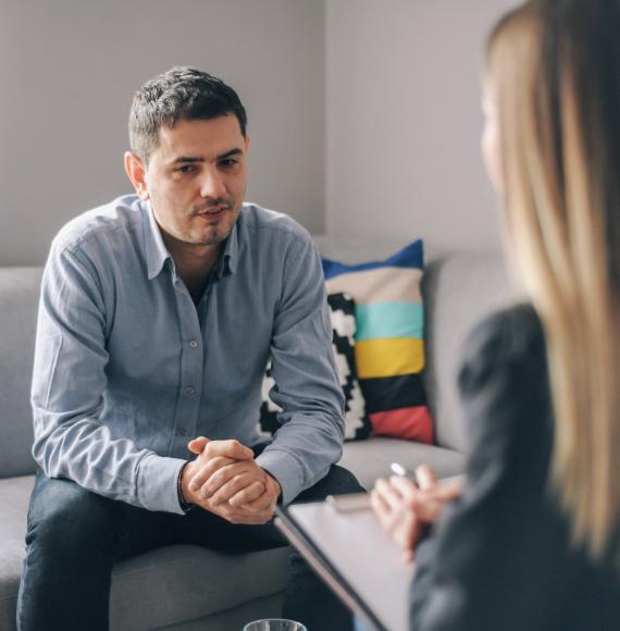 Female psychiatrist talking with male patient