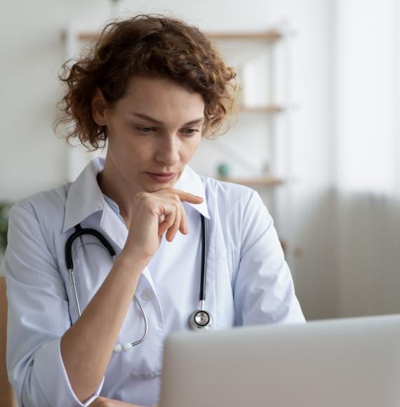 Health professional at a laptop