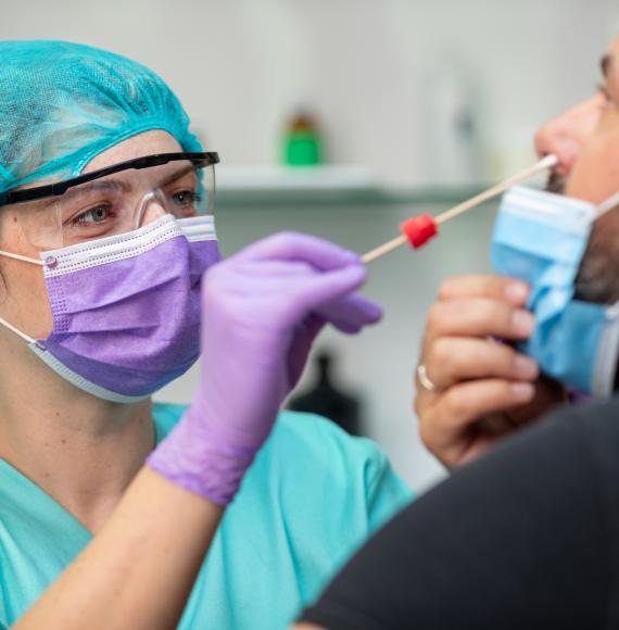 Female health professional carrying out a swab test on a patient