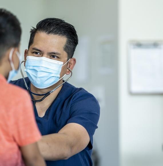 Male health professional seeing a young patient