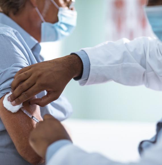 Male patient being administered a vaccine