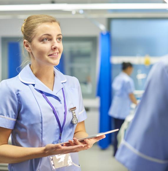 Female nurse in discussion with a colleague