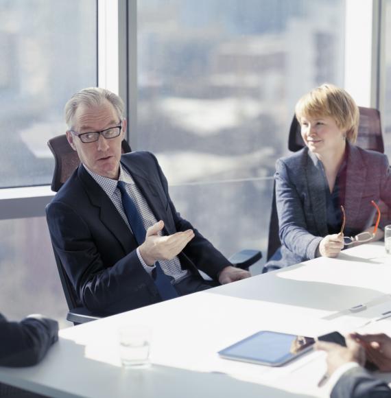 Discussion during a board meeting, soft focus background