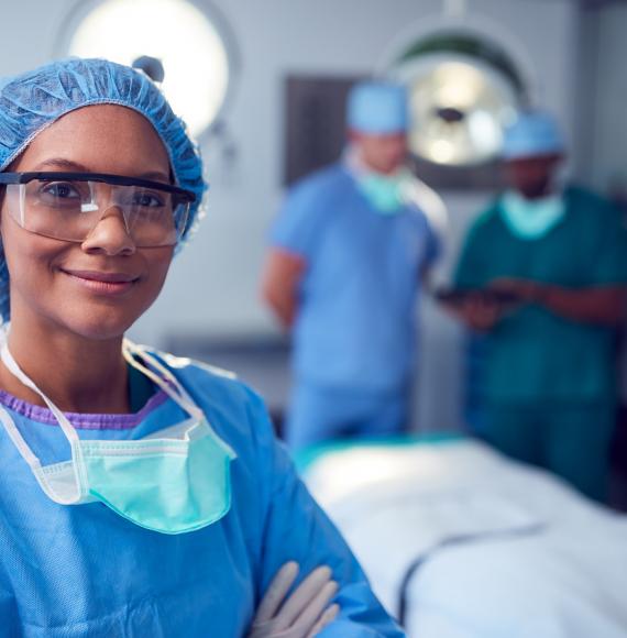 Surgical professional smiling toward the camera