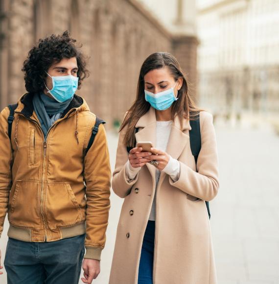 Man and woman wearing face masks walking