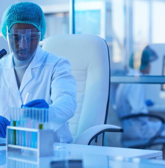 Male lab technician carrying out tests with lab equipment