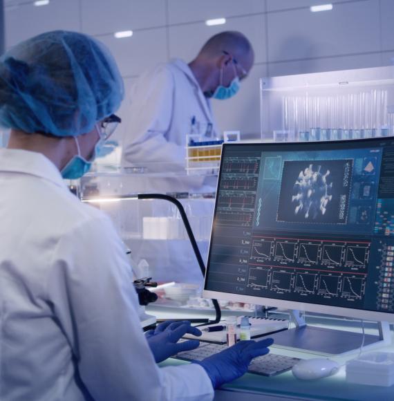 Lab technician operating a computer reviewing data