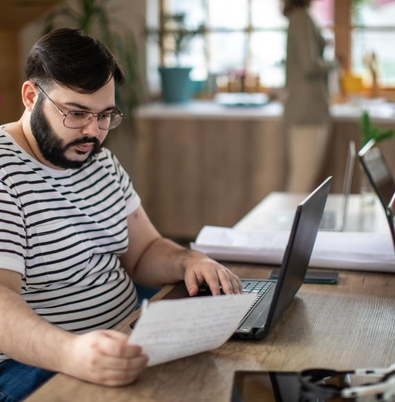 Overweight man at a laptop working