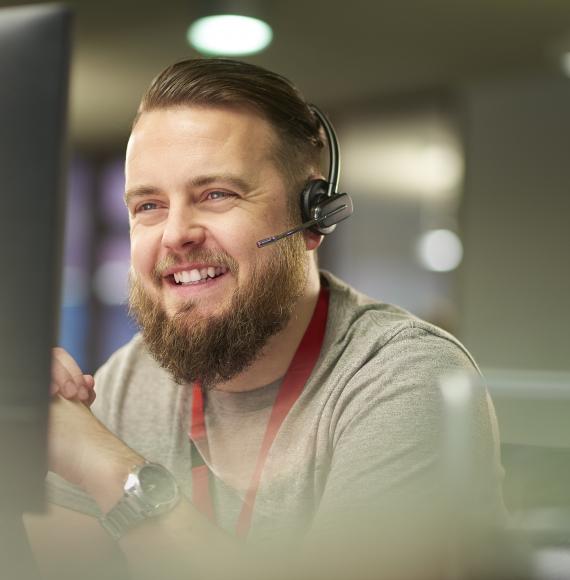Smiling male call operator talking on a headset