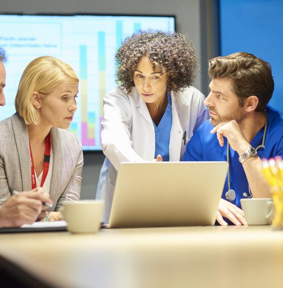 A range of health professionals discussing during a meeting