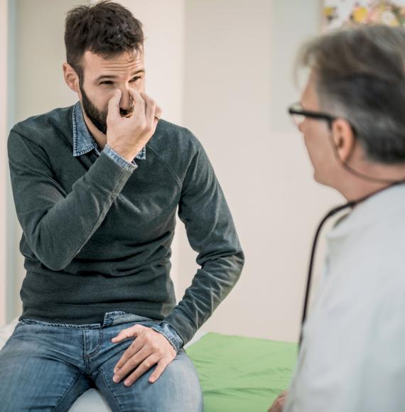 Male patient describing breathing troubles with a doctor