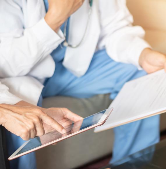 Two medical professionals looking at an iPad 