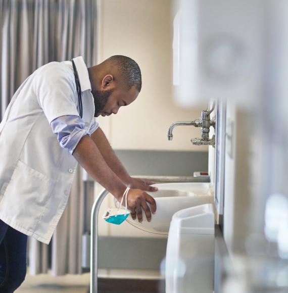 Stressed male doctor takes a moment for reflection