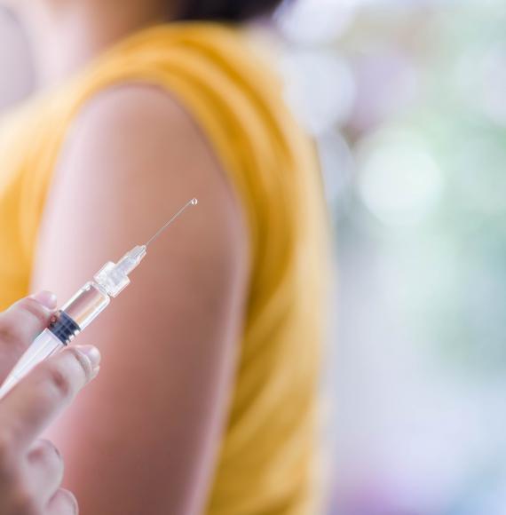 Close up of a needle before giving a vaccine jab