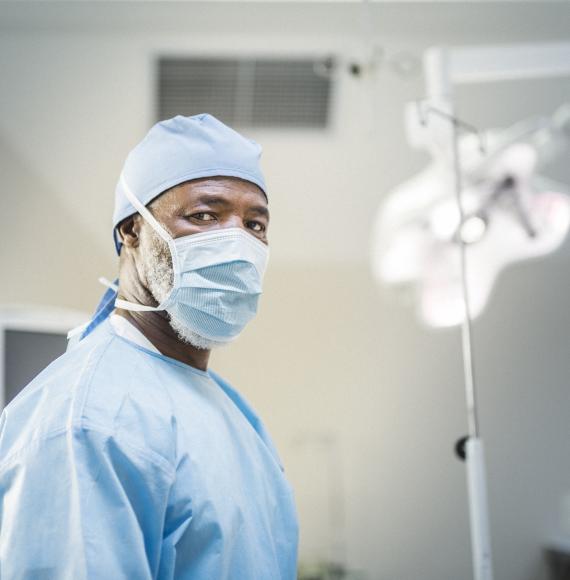 BAME surgeon standing in an operating theatre