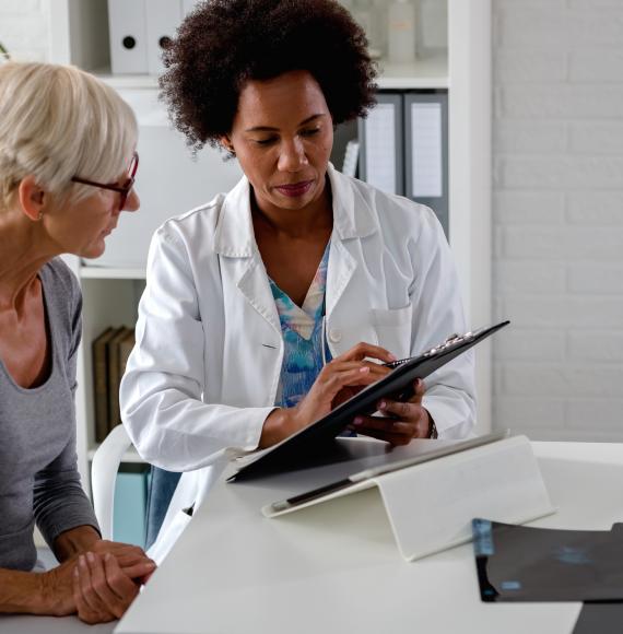 Female doctor at a desk discussing with a patient