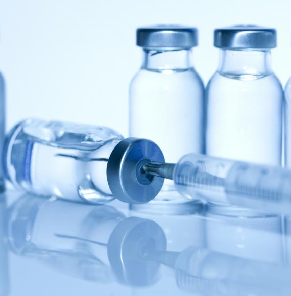 Vaccine bottle with syringe in the top
