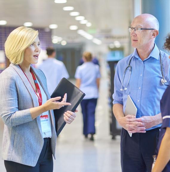 Hospital administrator in discussion with a doctor and nurse