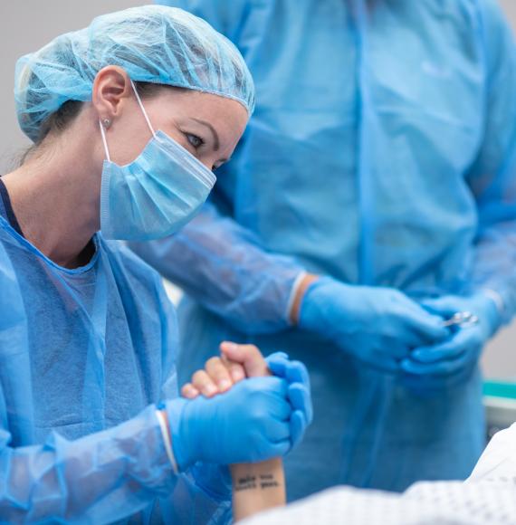 Health professional holding a female patient's hand