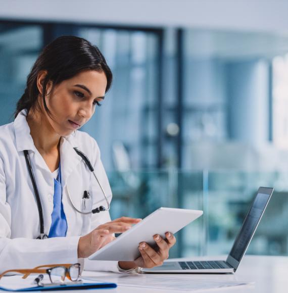 Female doctor using a tablet computer to manager her daily tasks