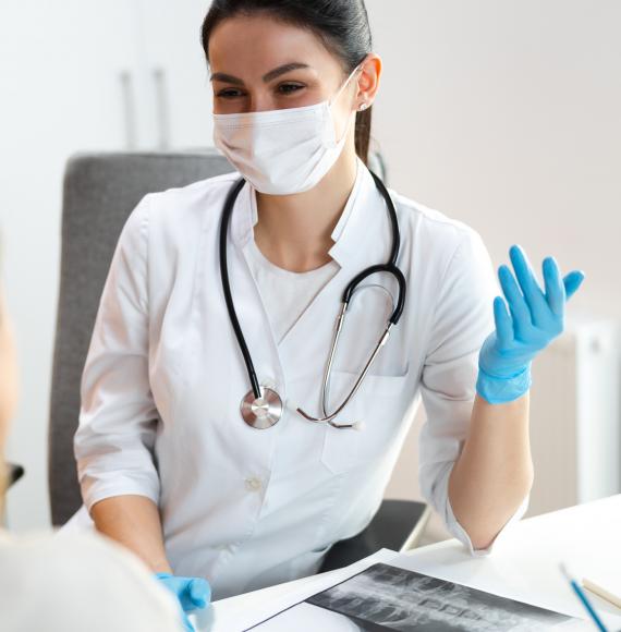 Young female doctor discussing with a patient