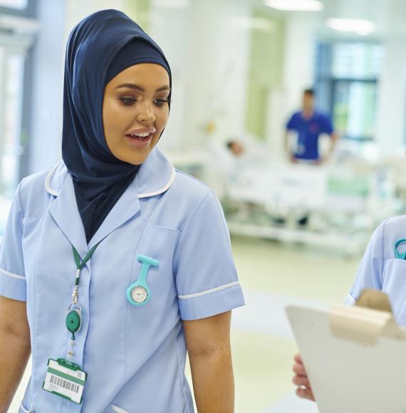 Nurses talking as they complete a ward round