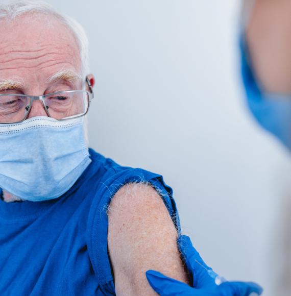 Elderly man preparing to receive his vaccine jab