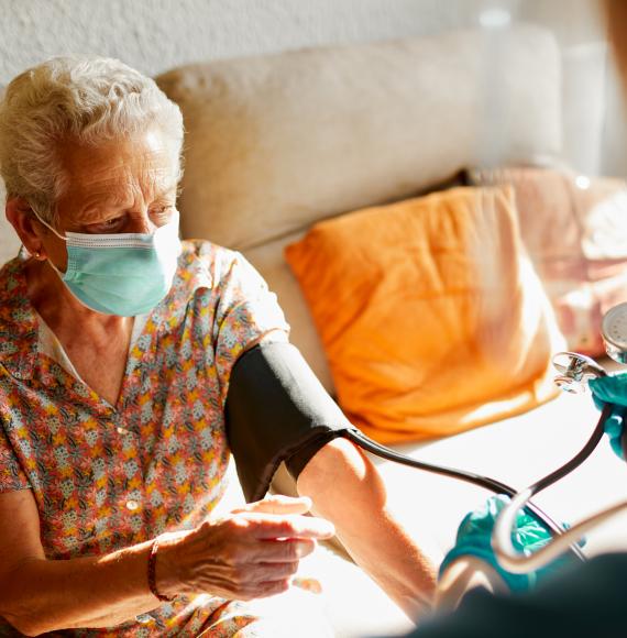 Care home patient having blood pressure taken