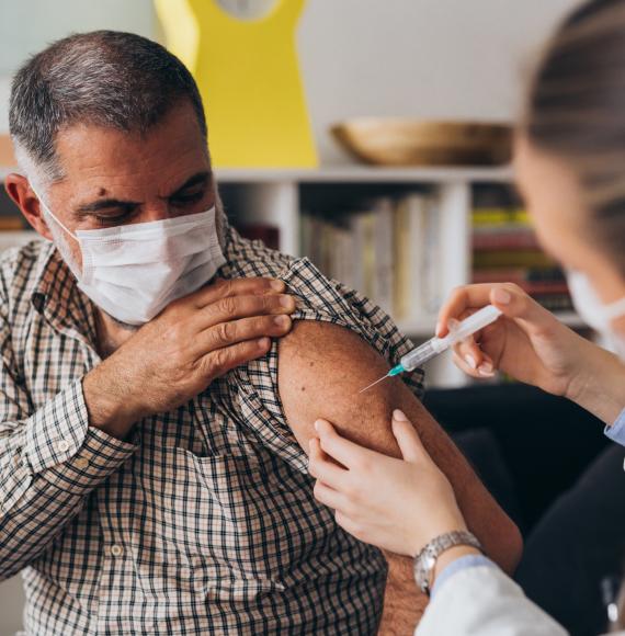 Doctor administering a vaccine jab