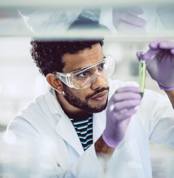 Scientist looking at a test tube in a lab