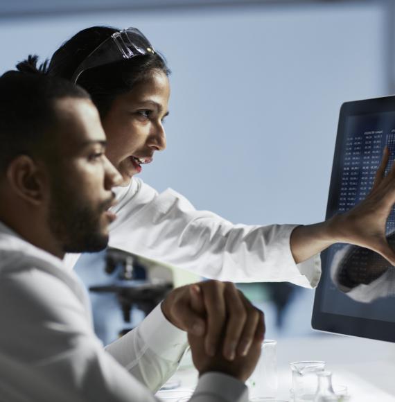 Medical researchers reviewing data on a screen