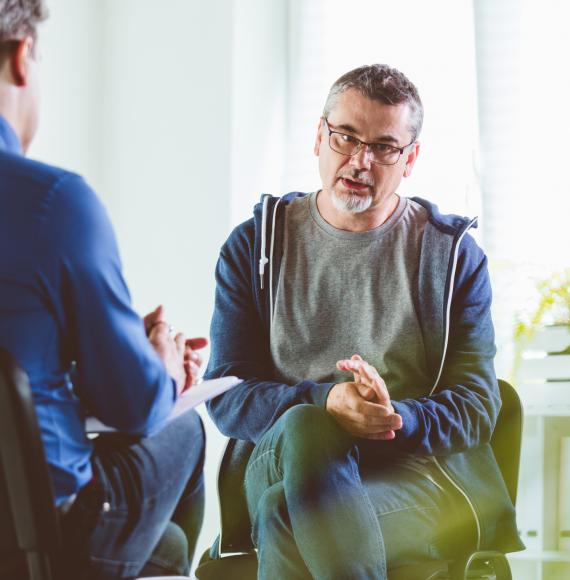 Older man talking with a mental health professional