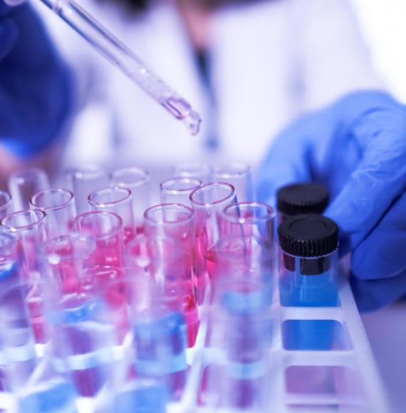 Lab technician using pipette and test tubes