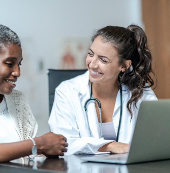 Female doctor discussing with a female patient about their care