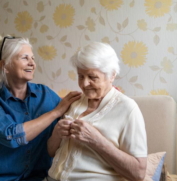 Woman helping elderly family member as an informal carer