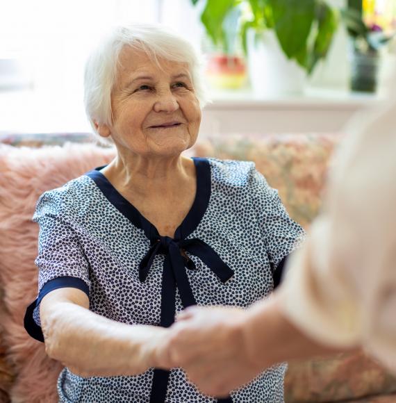 Care home resident talking with a staff member