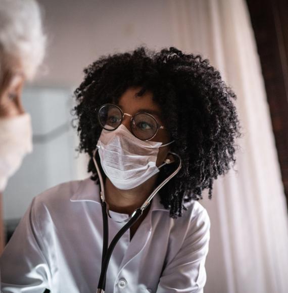 Woman providing medical care for an elderly patient