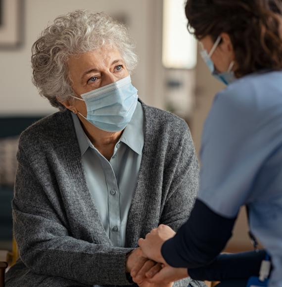 Elderly resident talking with a supportive carer