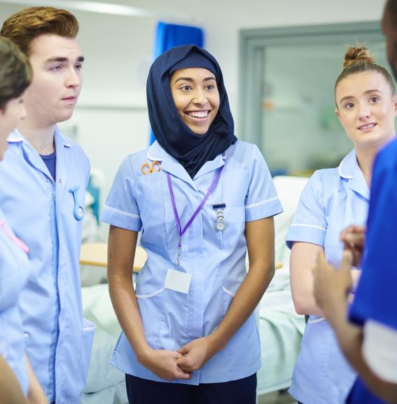 Group of young nurses learning from a colleague