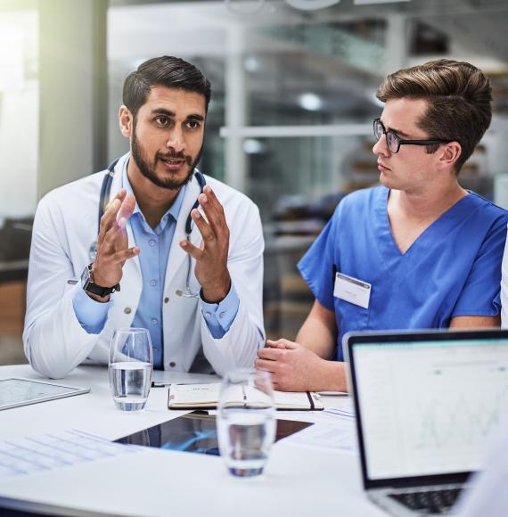 Young doctor discusses with a team of health professionals