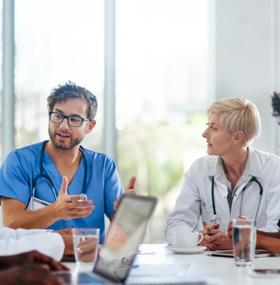 Doctors sat in a meeting discussing plans