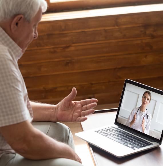Older man talking with a medical professional on a video call
