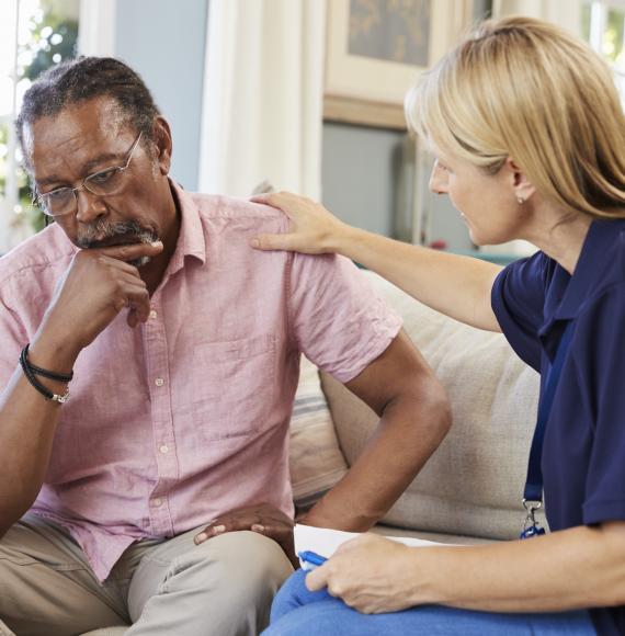 Social worker talking with an older man