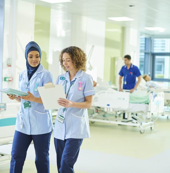 Nursing walking down a ward