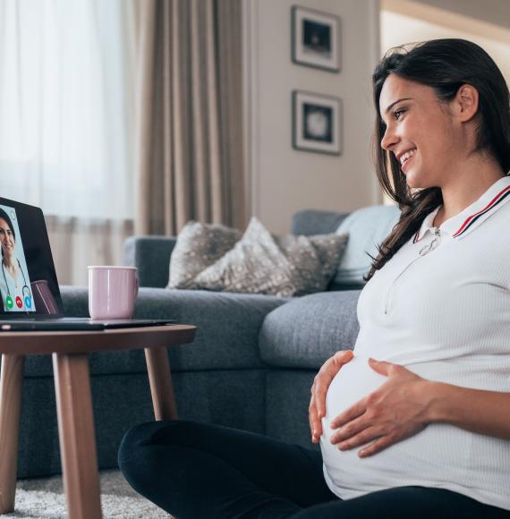 Pregnant woman talking remotely with a clinician