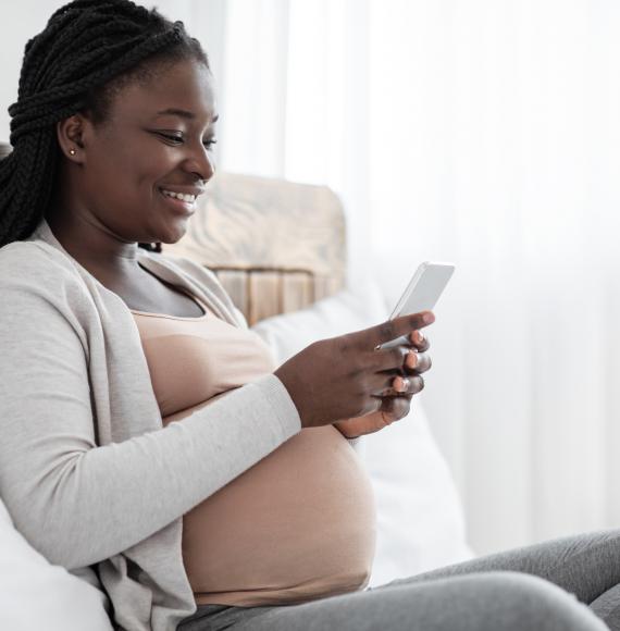 Pregnant woman using a mobile phone