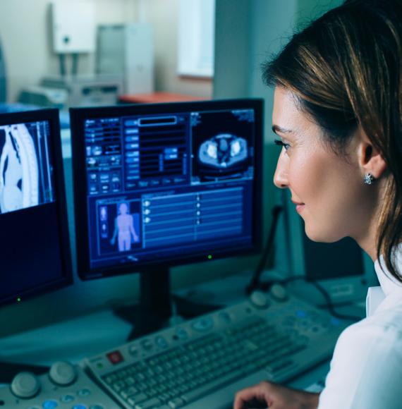 Female radiographer looking at a chest CT scan