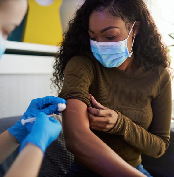 Vaccine jab being administered by a health professional